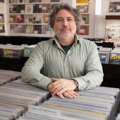 Darren Revilla, Owner of Revilla Grooves and Gear inside the record store.