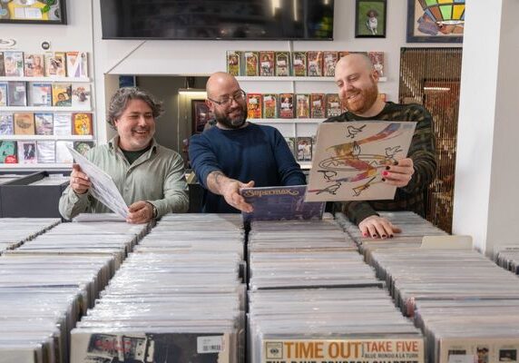 Revilla Grooves and Gear Owner, Darren Revilla, and employees picking out records.