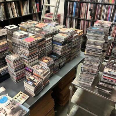 Stacks of cd's at Revilla Grooves and Gear. We buy cd's.